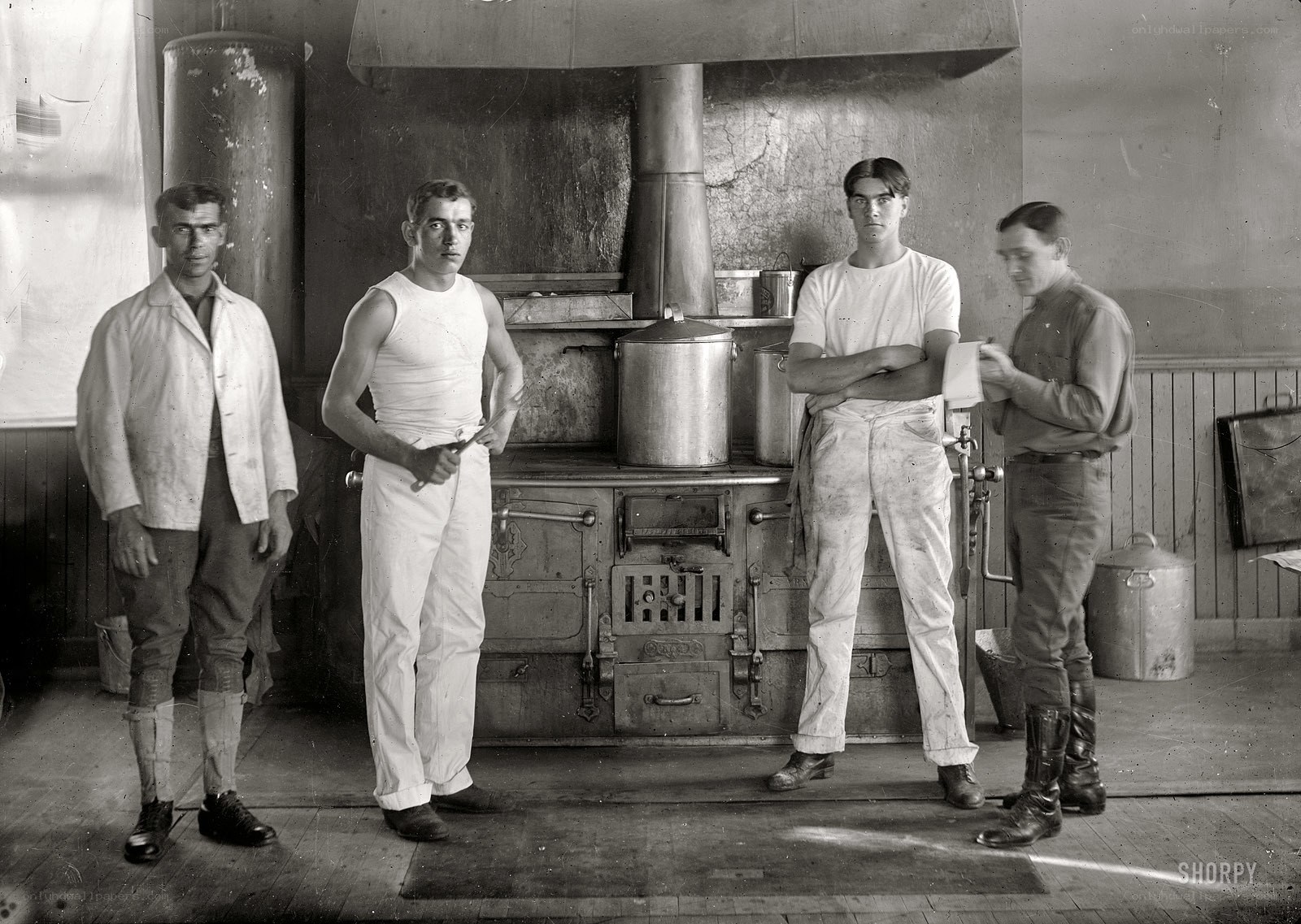 Four men in a kitchen