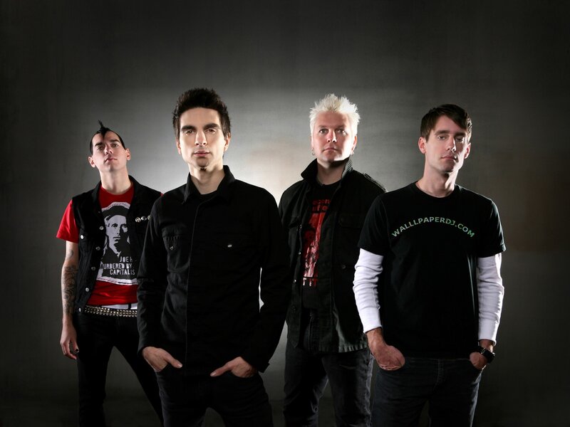 Four Men in Band Attire — Black, Serious, Photograph, Band Members