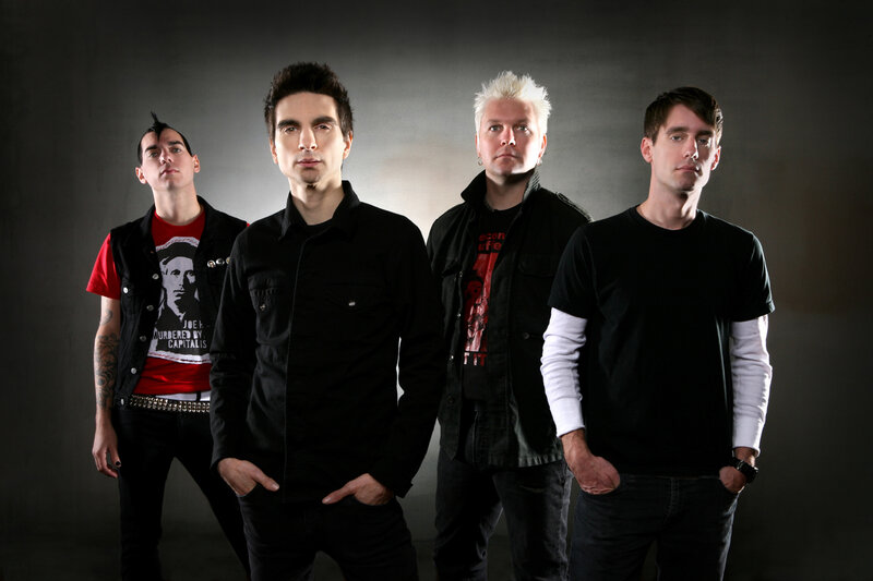 Four Men in Band Attire — Black, Serious, Photograph, Tattoo