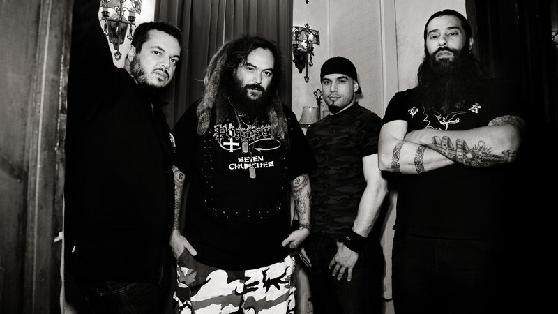 Four Men in Band Attire — Black, Serious, Photograph, Tattoos