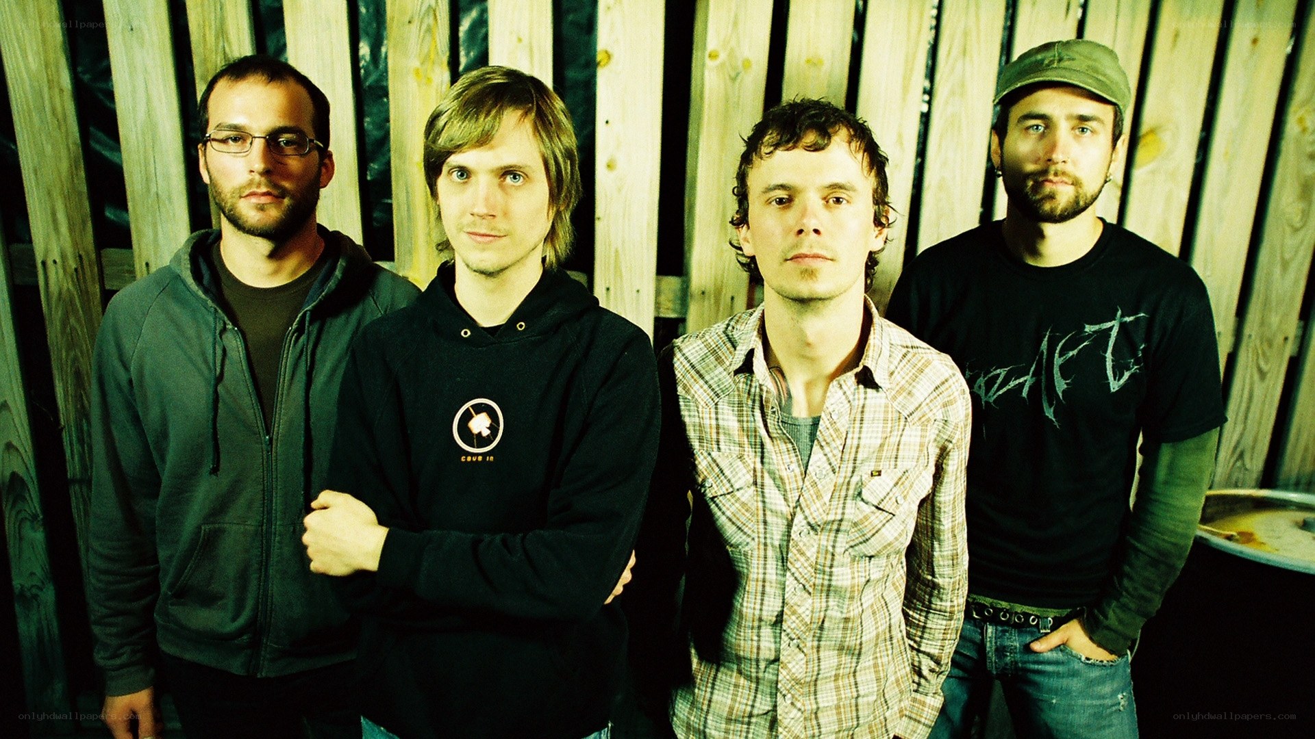 four men in band pose