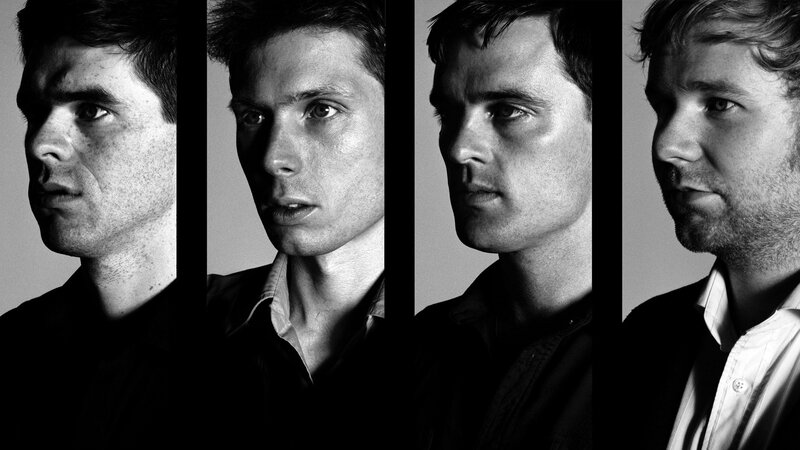 four men in black and white portraits