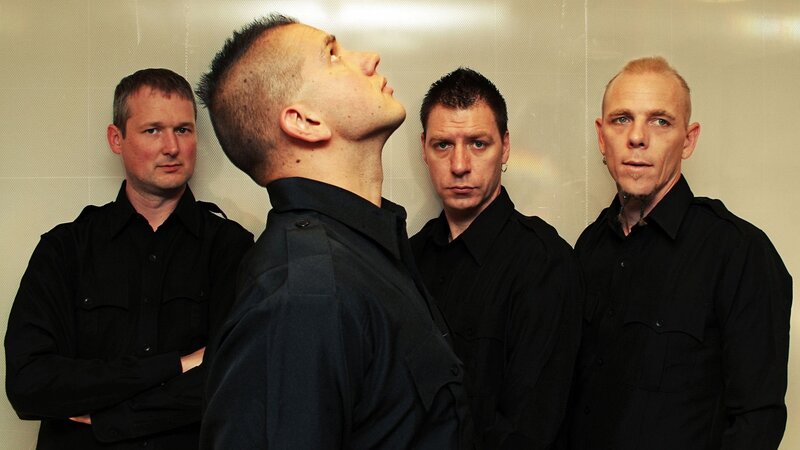 Four Men in Black Shirts — Serious, Photograph, Wall