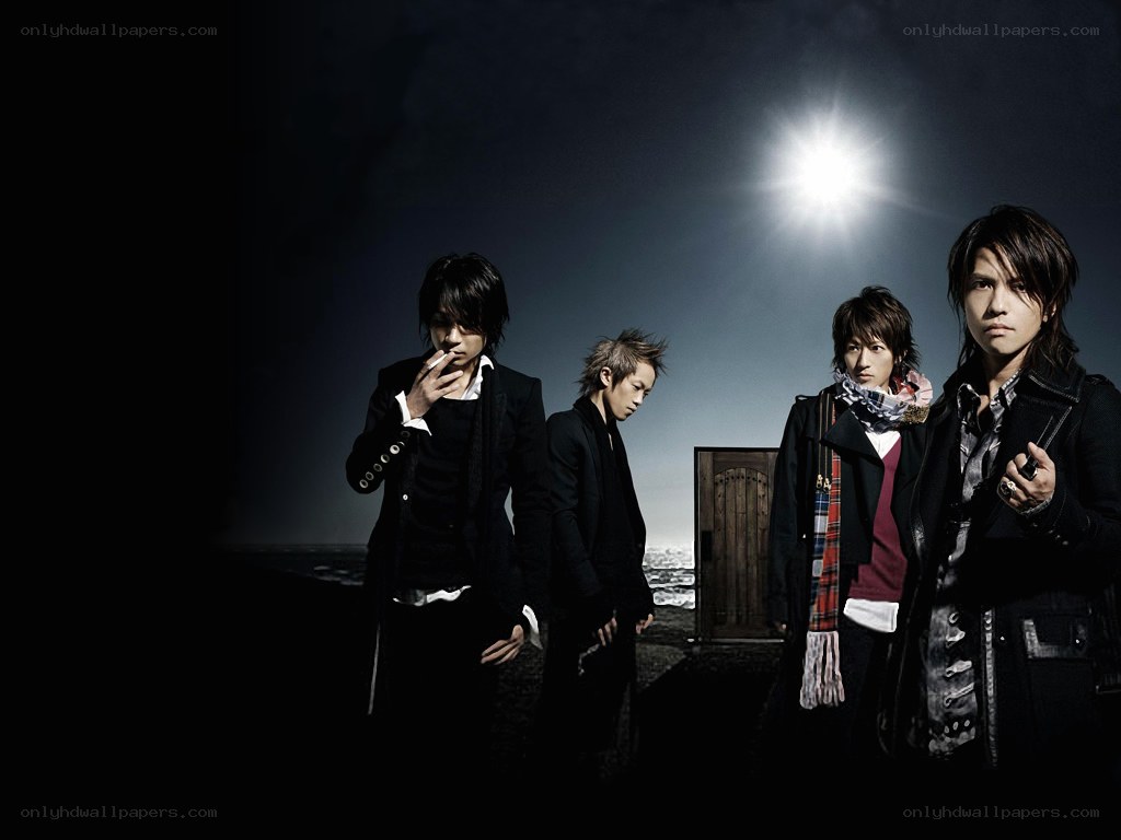 four men in dark clothing