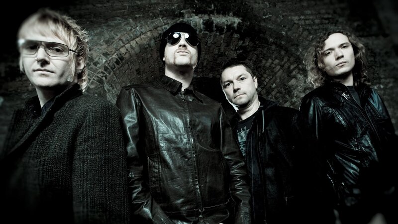 Four Men in Dark Clothing — Black, Serious, Photograph, Brick Wall