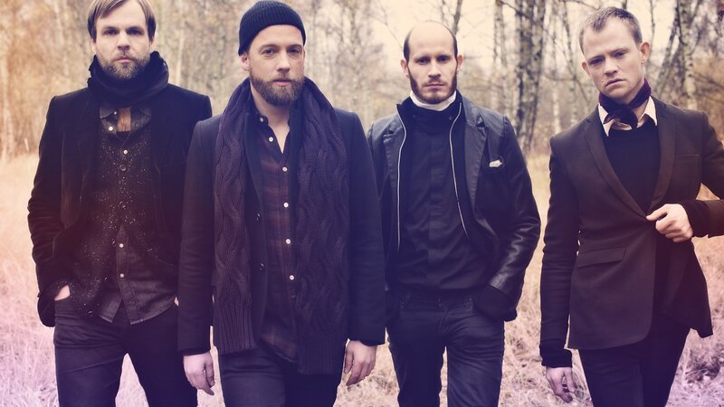 four men in dark clothing