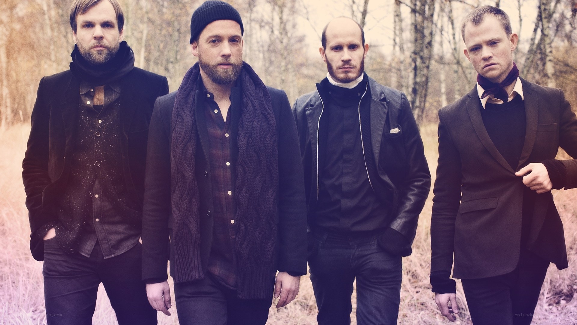 four men in dark clothing