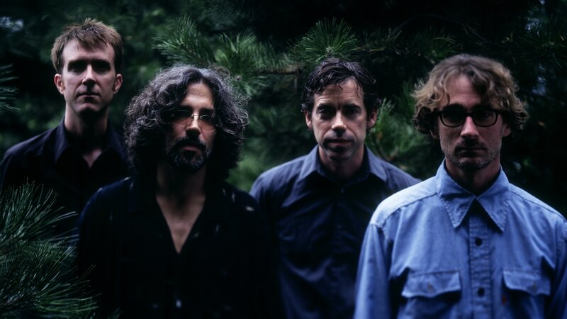 Four Men in Forest — Green, Serious