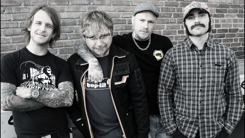 Four Men in Front of Brick Wall — Black, Neutral