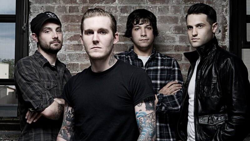 Four Men in Front of Brick Wall — Black, Serious
