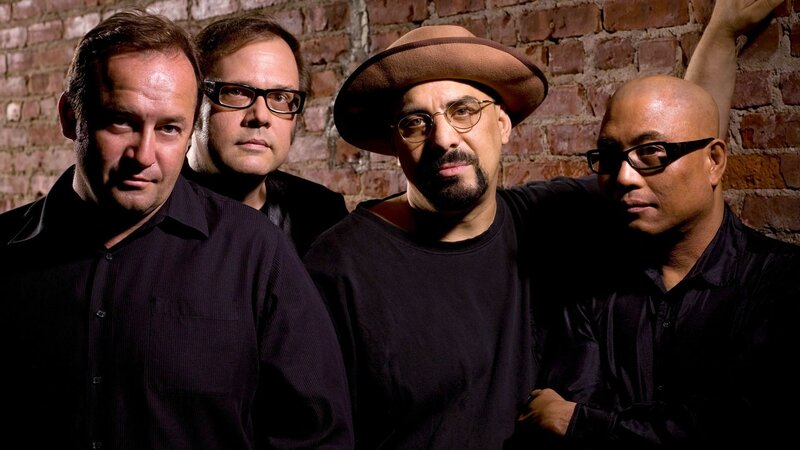 Four Men in Front of Brick Wall — Brown