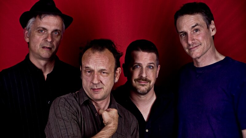 Four Men in Front of Red Wall — Neutral