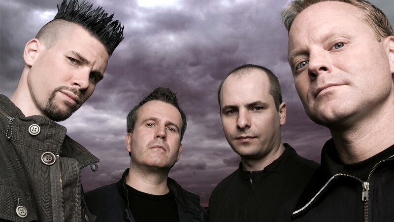 Four Men in Front of Stormy Sky