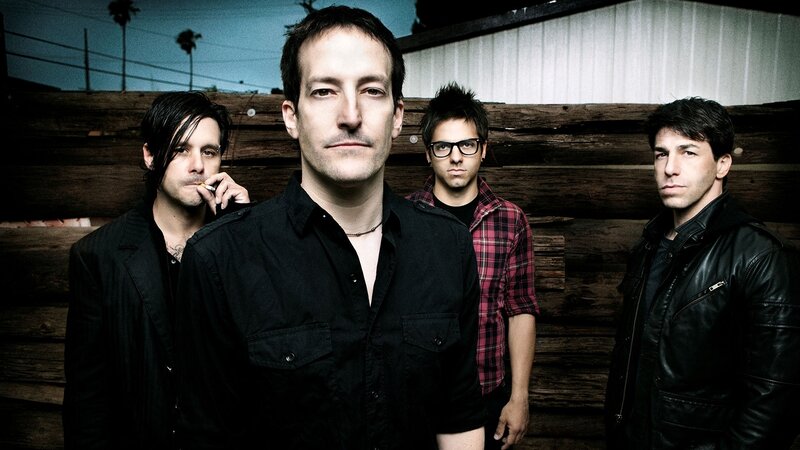 Four Men in Front of Wood Wall