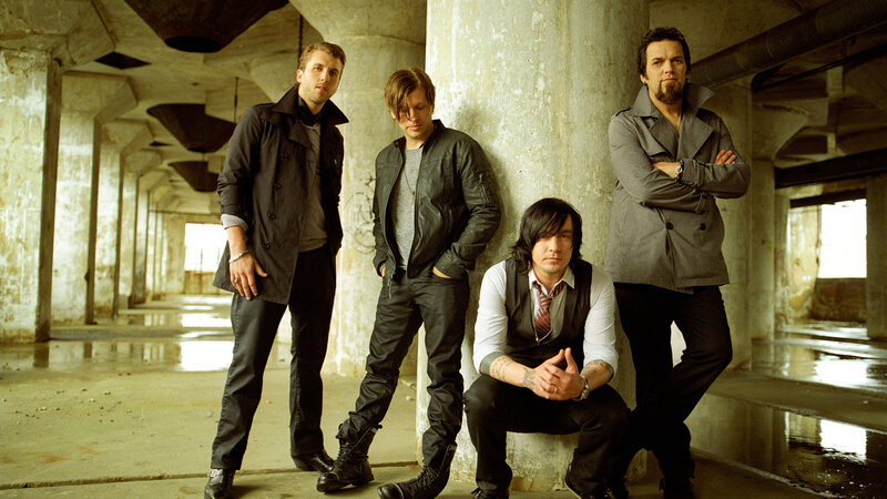 Four Men in Industrial Setting — Gray