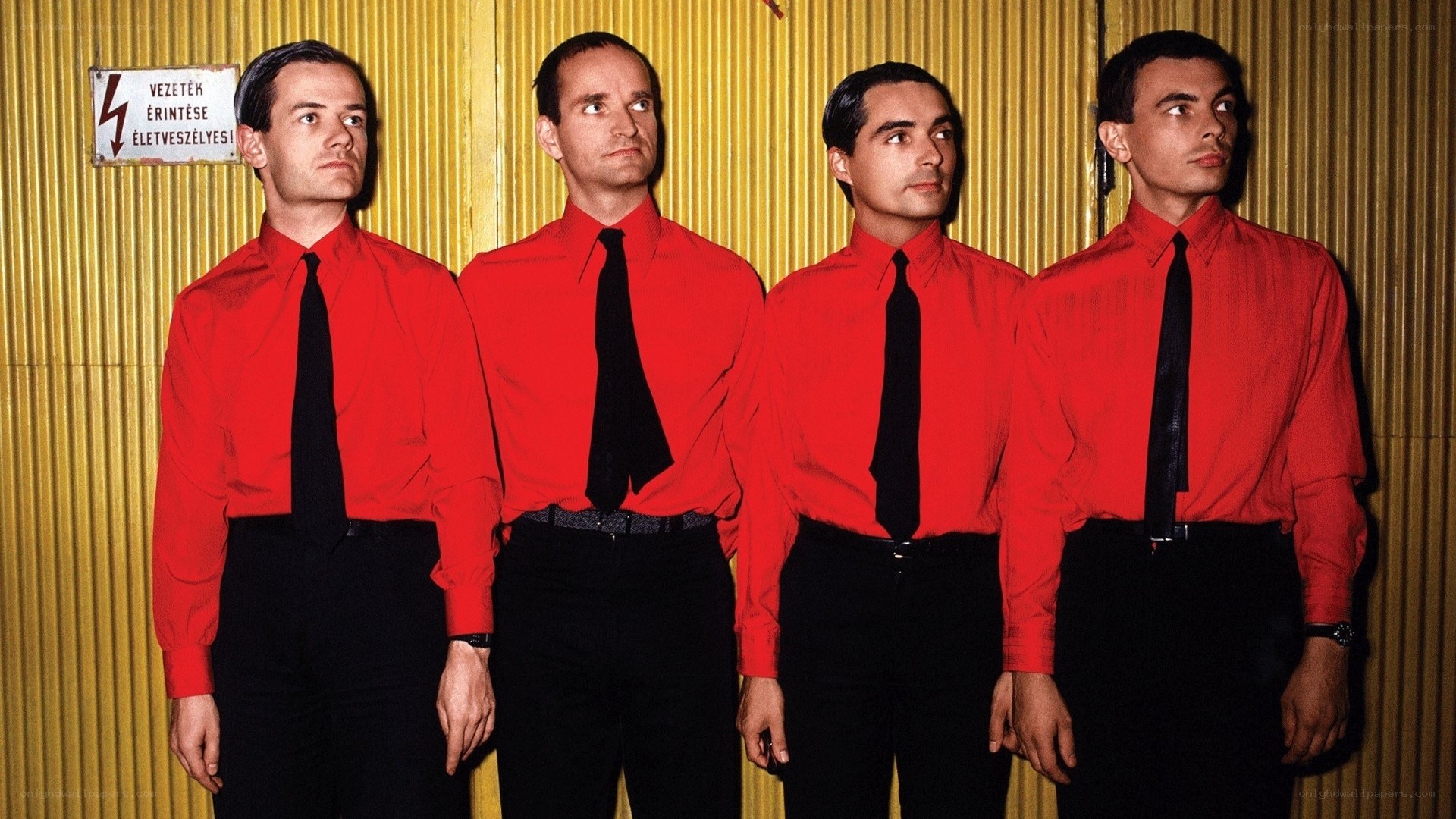 Four men in red shirts