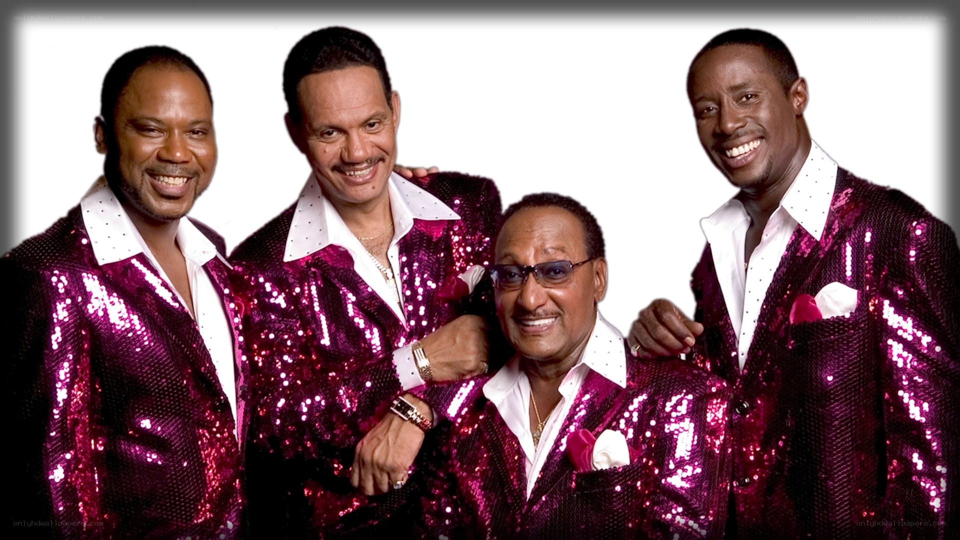 Four men in sequin jackets