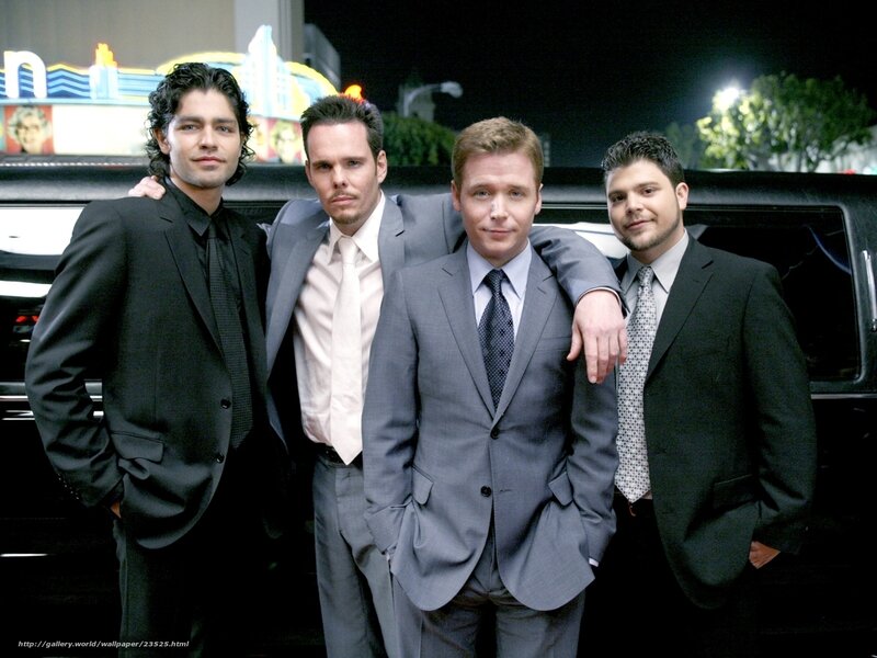four men in suits at night