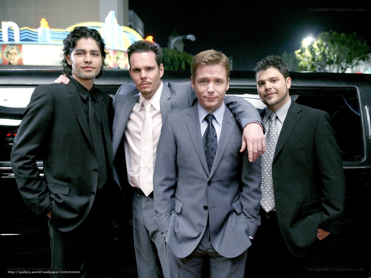 four men in suits at night