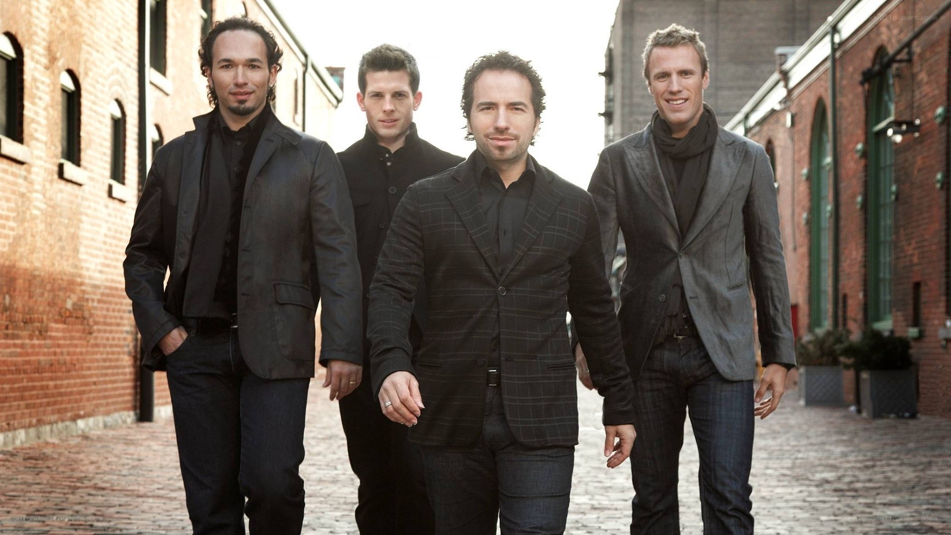 four men in suits walking