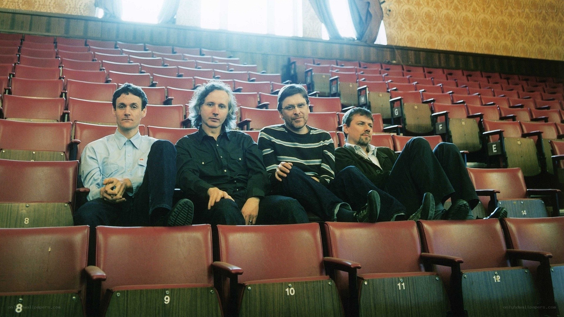 Four men in theater seats