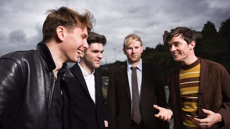four men laughing together