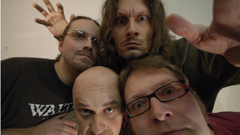 Four men making funny faces