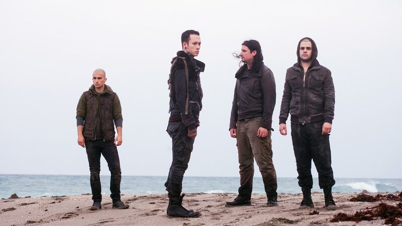 four men on a beach