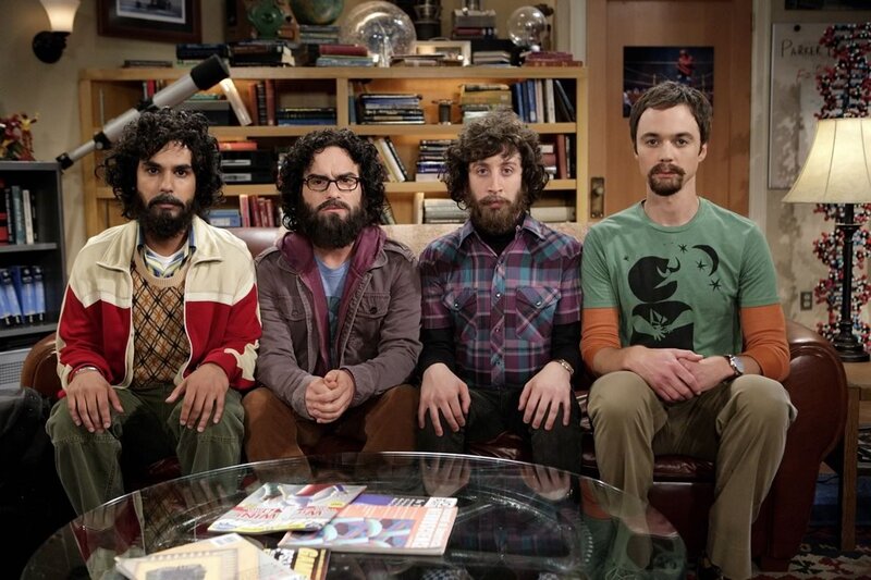 Four men on a couch in a living room