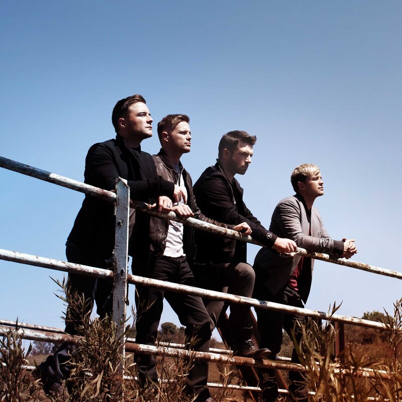 four men on a fence