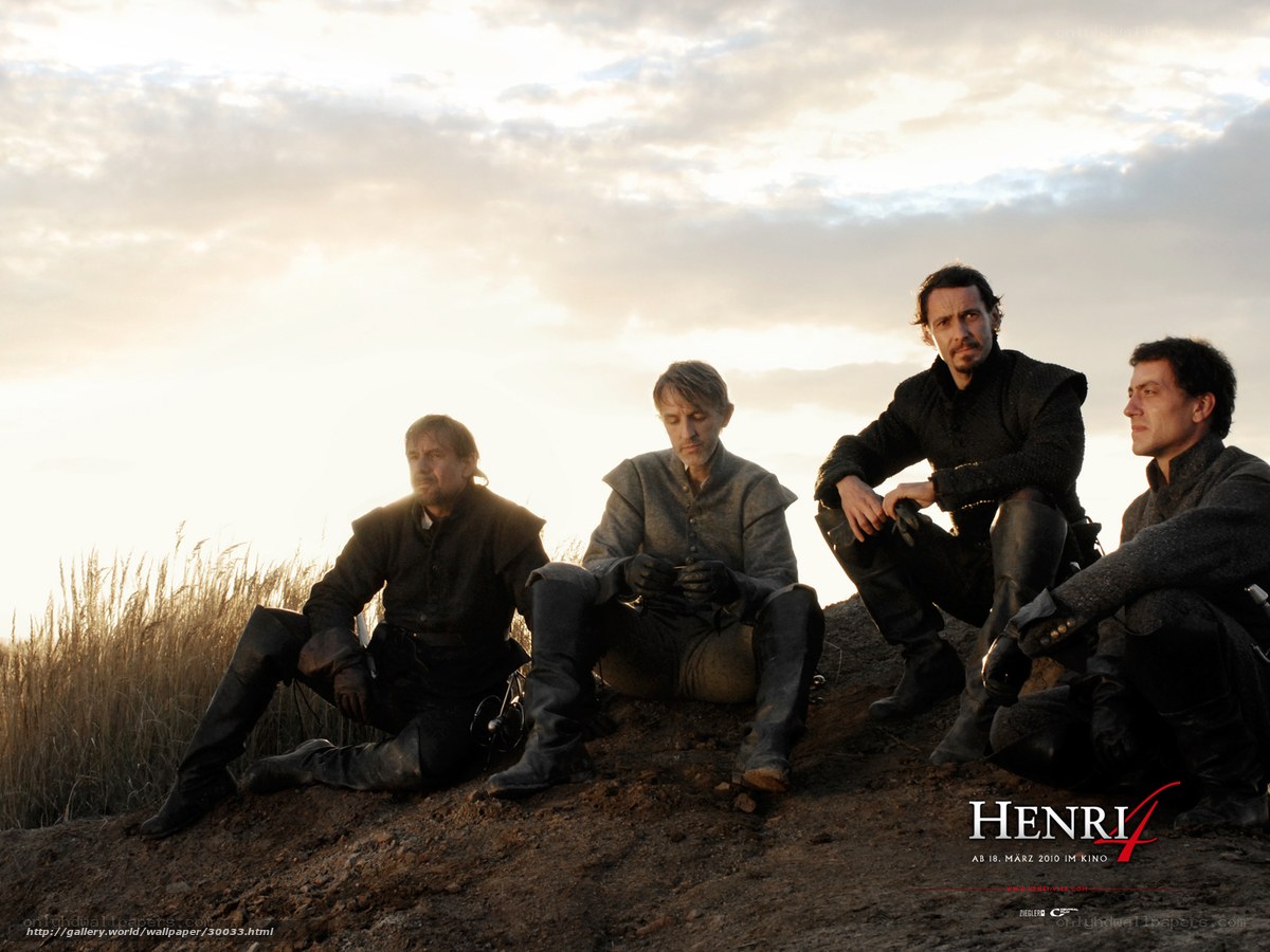 Four men on a hill at sunset