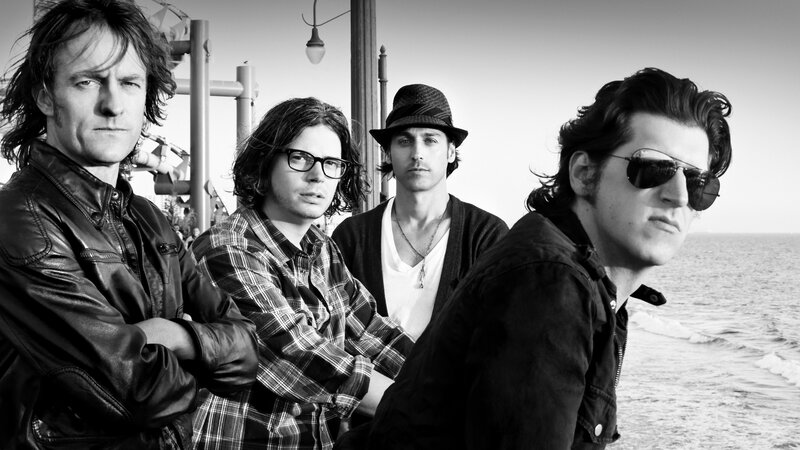 Four Men on Beach — Black, Serious