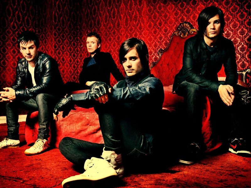 Four Men on Red Couch — Dramatic, Photograph