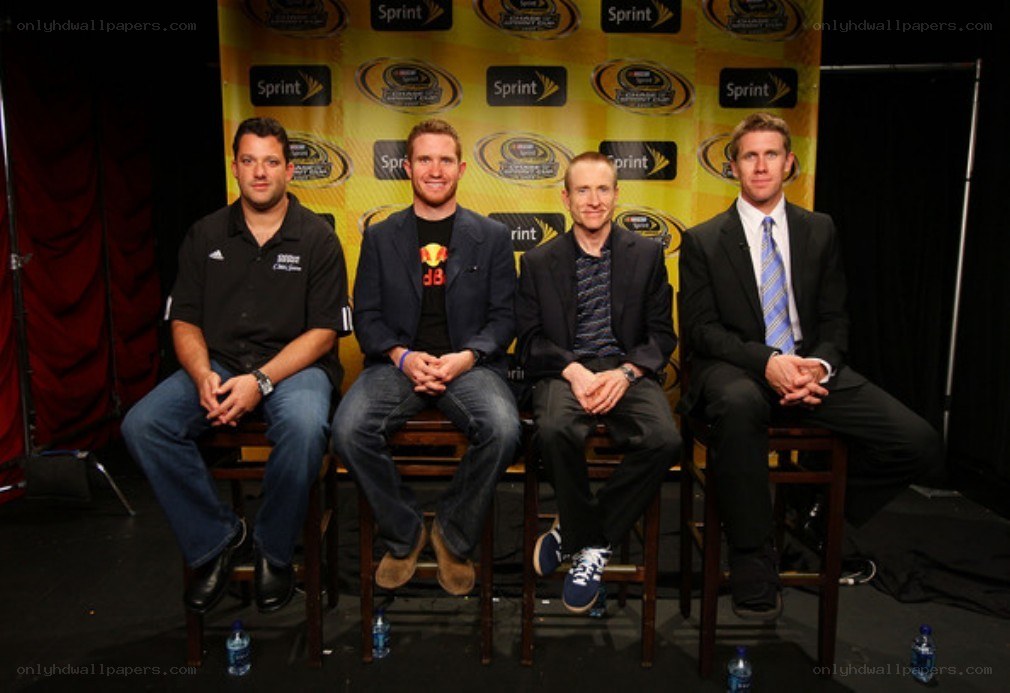 four men on stage at event