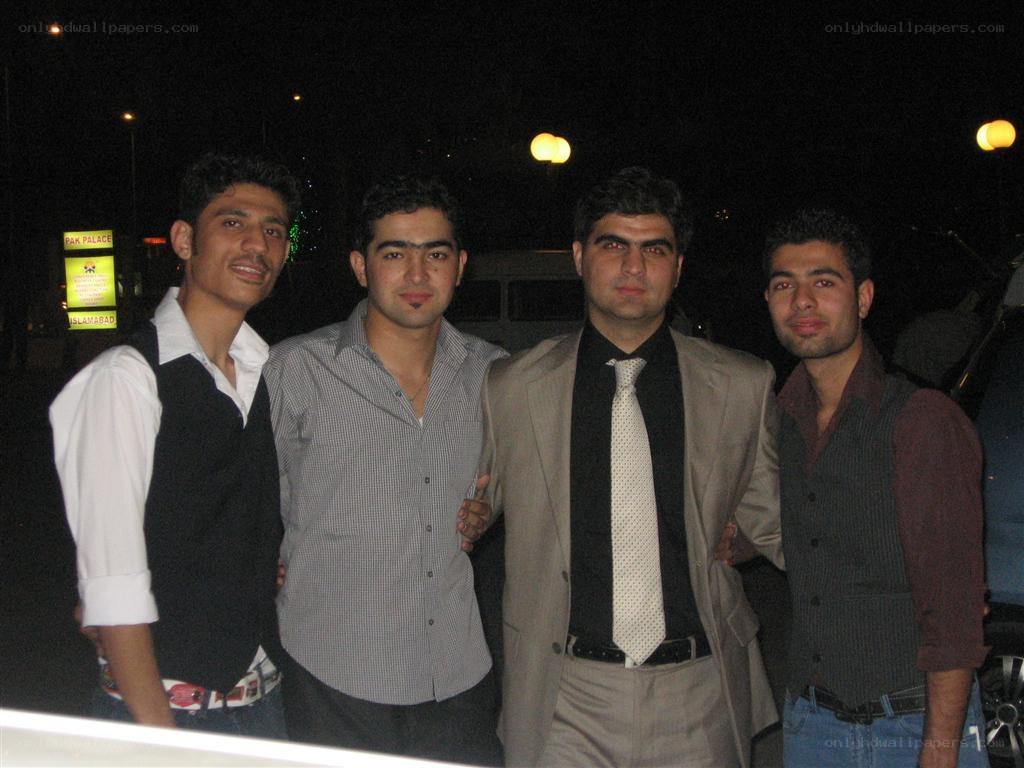 four men posing at night