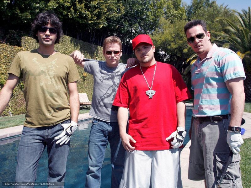 Four men posing by a pool