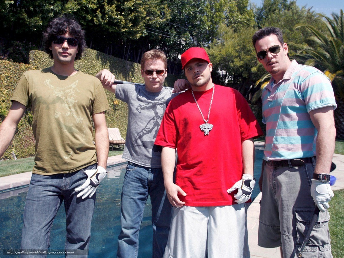 Four men posing by a pool
