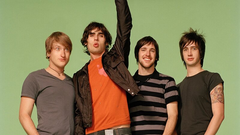 Four Men Posing Together — Green