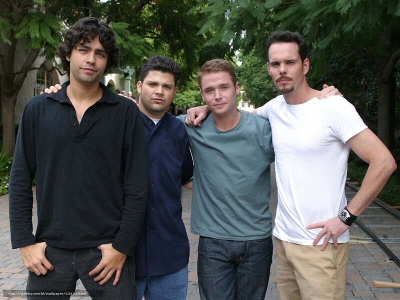 four men posing together outdoors