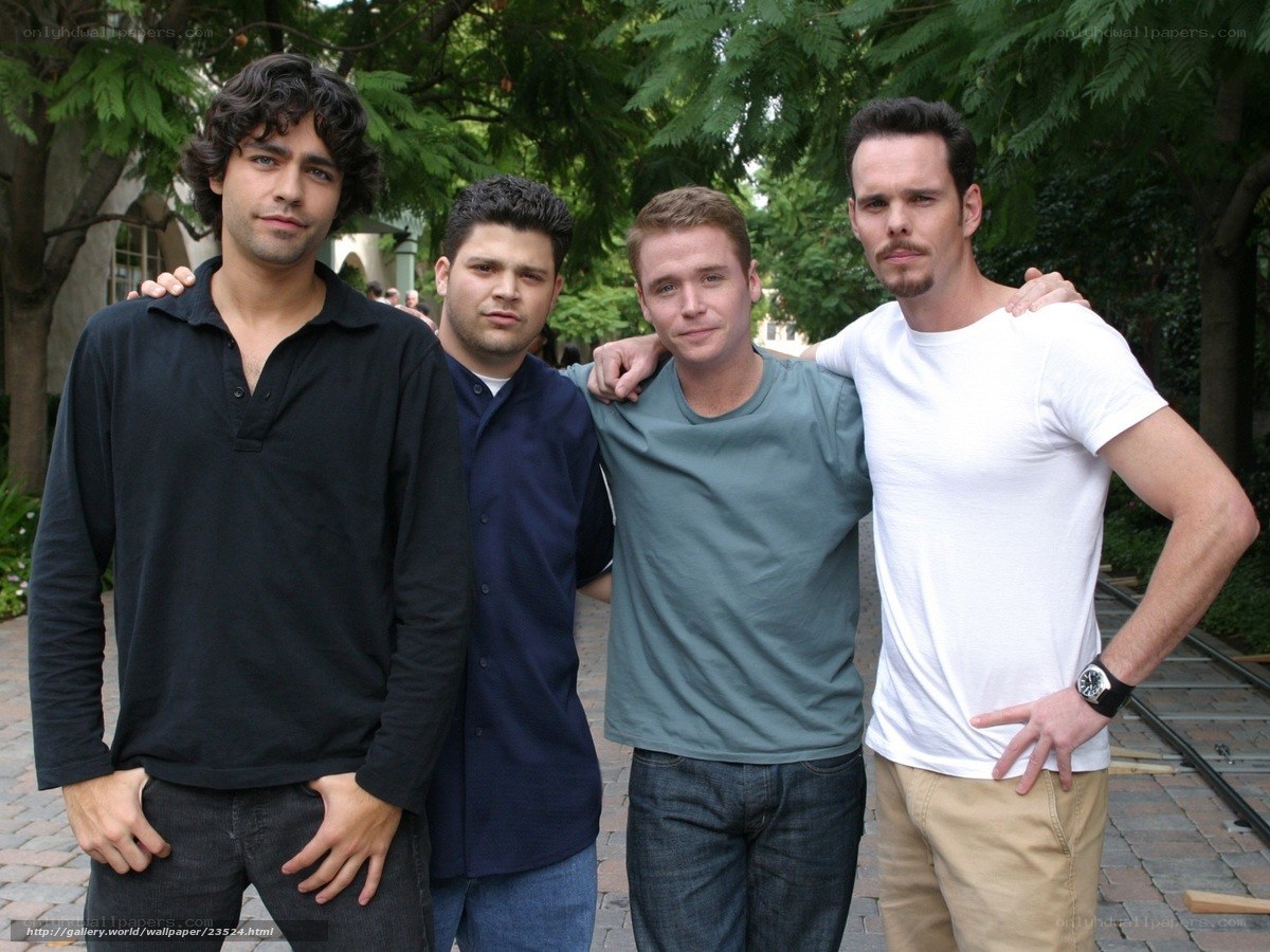 four men posing together outdoors