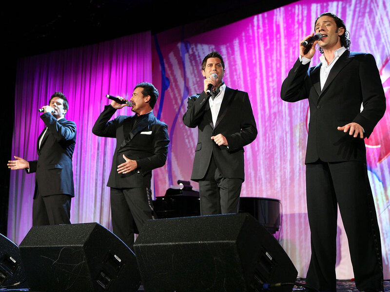 Four Men Singing on Stage — Black
