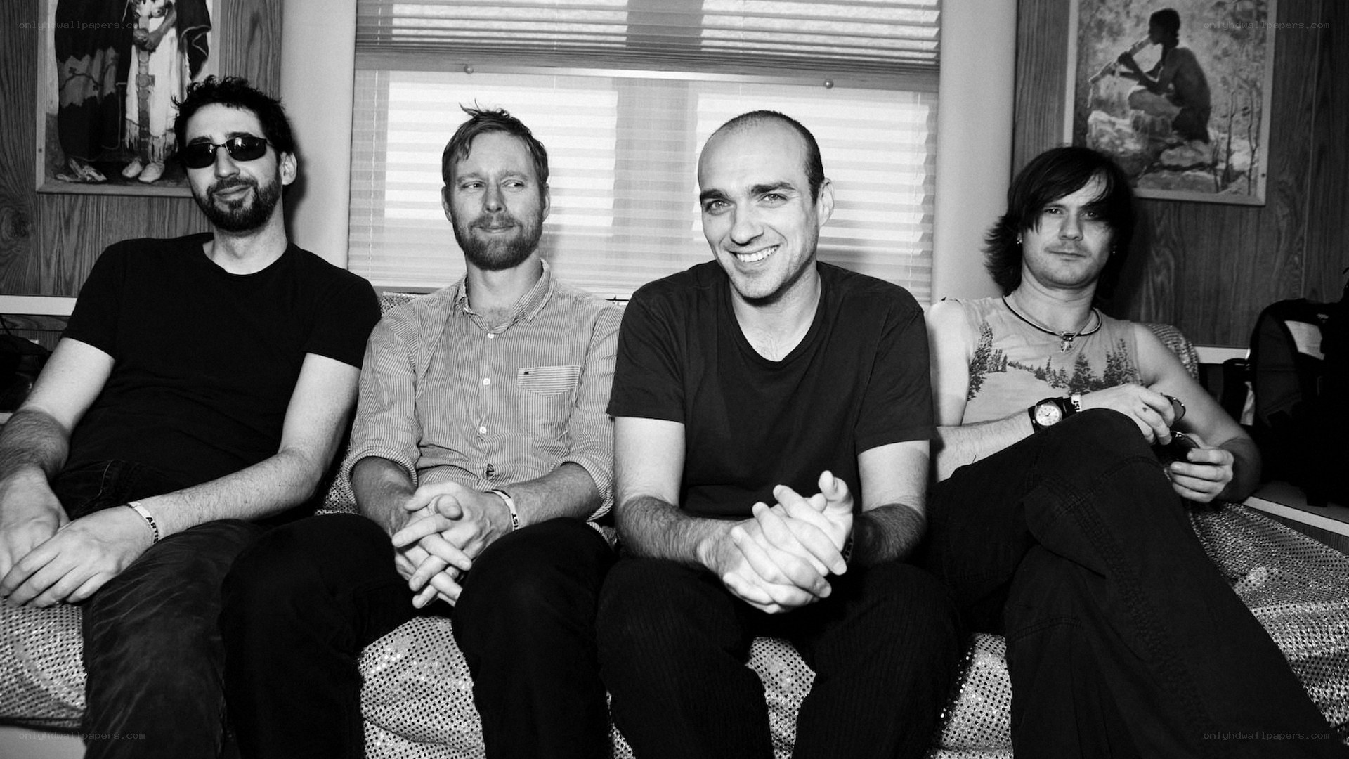 four men sitting on a couch