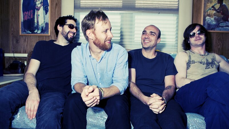 Four Men Sitting on Couch