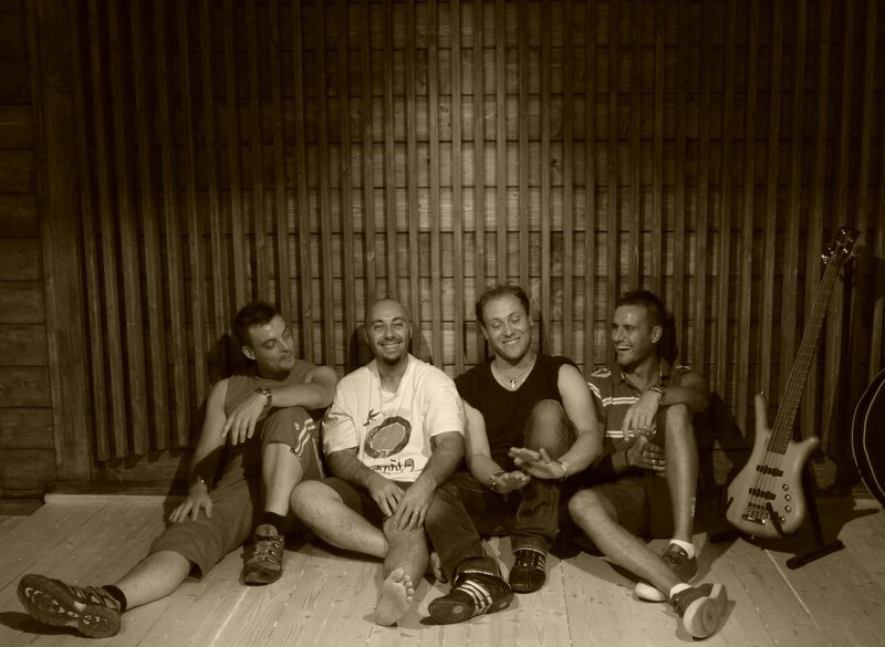 Four Men Sitting on Floor — Brown