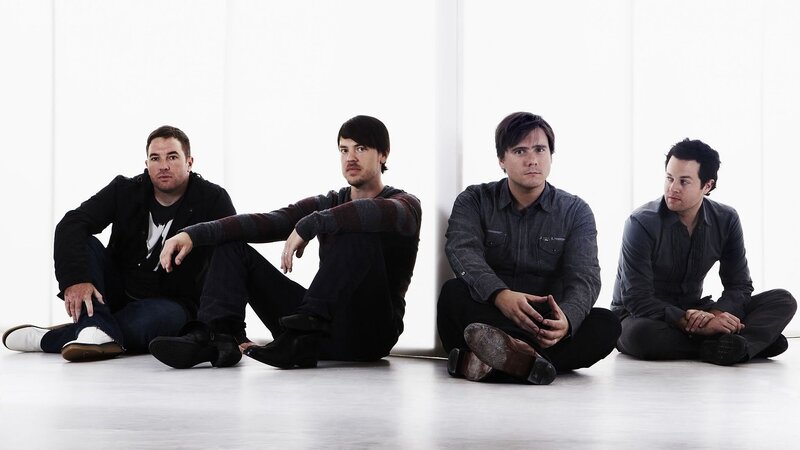four men sitting on floor