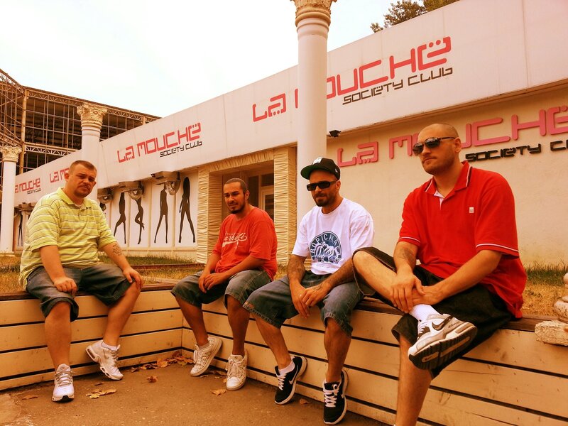 Four men sitting outside a club