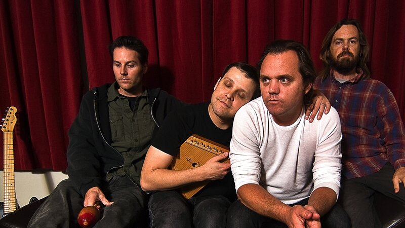 Four Men Sitting Together — Red
