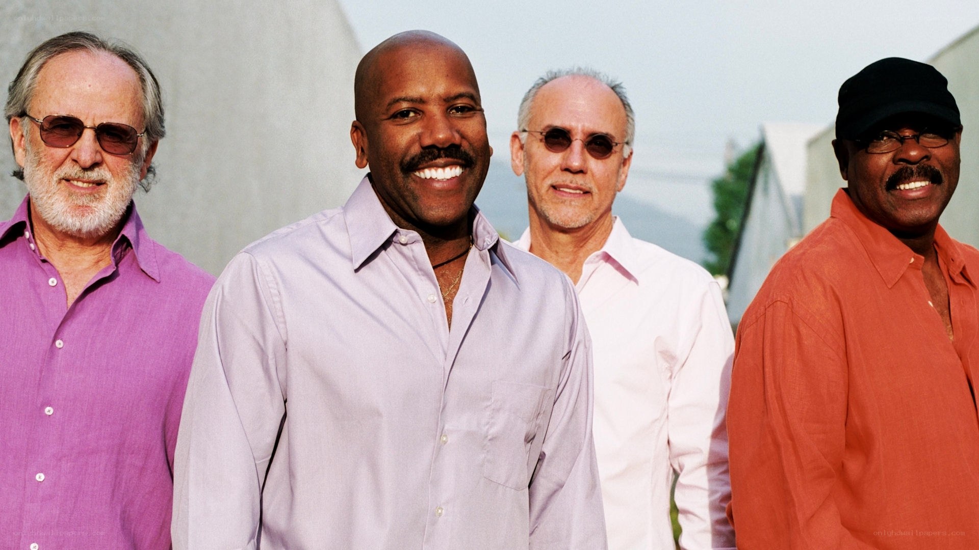 four men smiling together