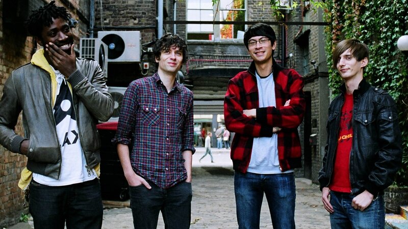 four men standing in alley