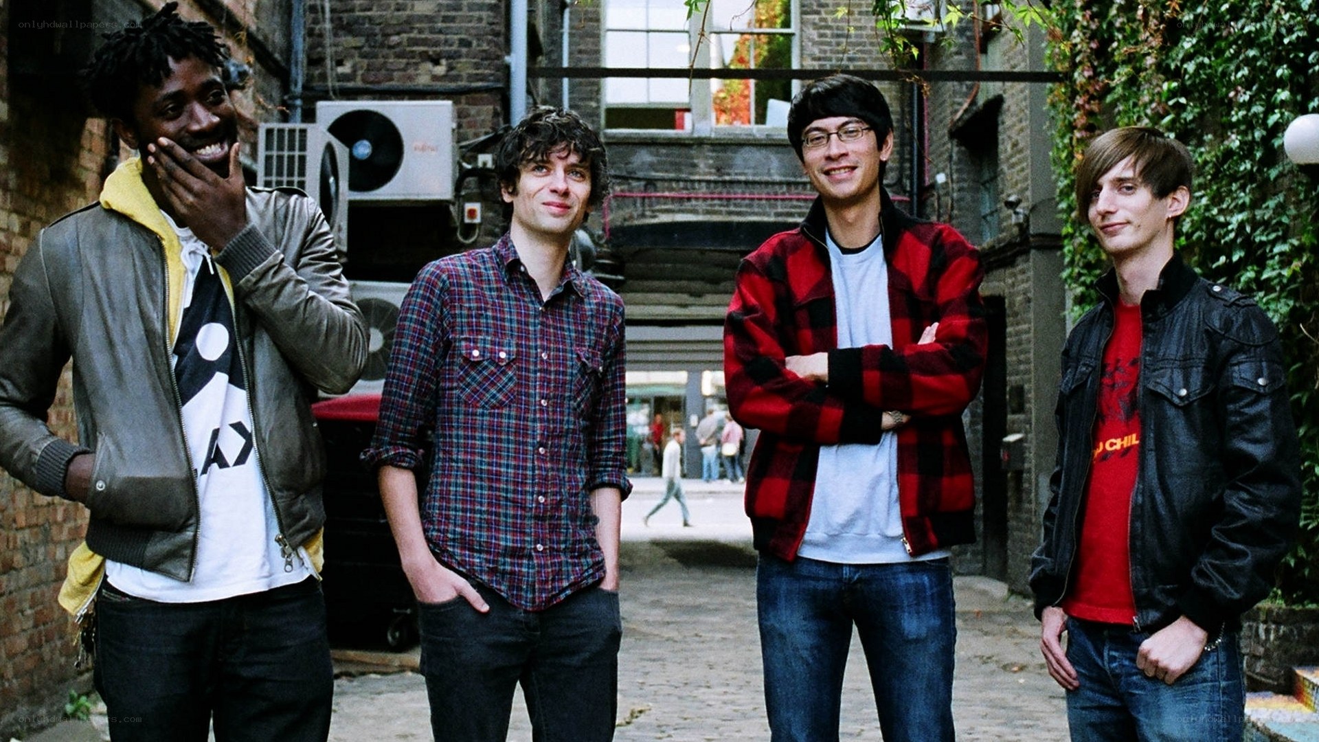 four men standing in alley